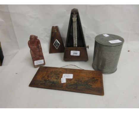 Mahogany metronome, carved soapstone figure, Chinese pewter box and cover and a small wooden plaque made from the ship Eurydi