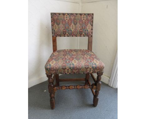 Set of six reproduction oak dining chairs with upholstered backs and seats raised on bobbin turned supports with stretchers
