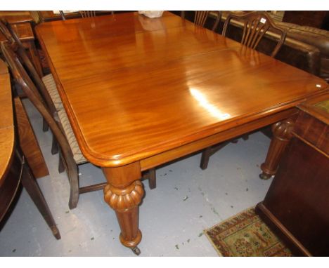 Victorian mahogany extending dining table, the moulded top with a shallow frieze raised on turned fluted supports with brass 