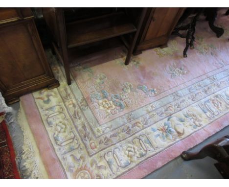 Chinese woollen carpet with floral decoration and multiple borders on a pink ground, approximately 12ft x 9ft