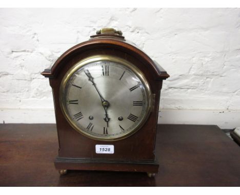 Early 20th Century mahogany bracket clock, the broken arch case with a circular silvered dial and Roman numerals, the two tra