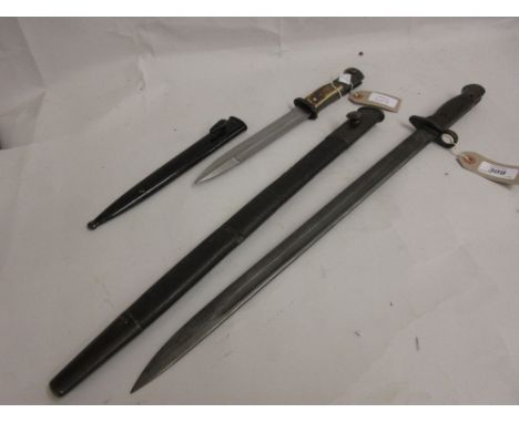 Early 20th Century bayonet with scabbard, together with a small horn handled bayonet with scabbard