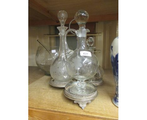 Group of three various glass decanters mounted on a plated stand together with a modern glass punch bowl with ladle