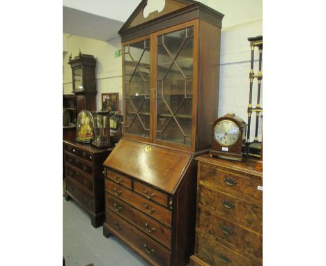 George III mahogany marquetry and line inlaid bureau bookcase, the blind fretwork cornice with a broken arch pediment above t