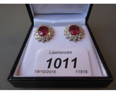 Pair of 18ct white gold diamond and treated ruby cluster earrings, the rubies approximately 6.43ct, the diamonds approximatel