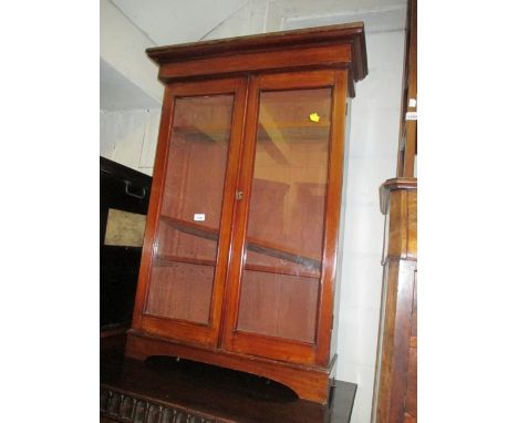 Small late 19th Century mahogany two door bookcase with bracket feet