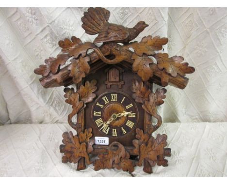 19th Century cuckoo clock having carved oak leaf decoration with weights and pendulum