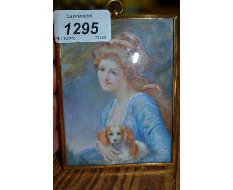Early 20th Century watercolour portrait miniature of a girl with a spaniel housed in a gilt metal frame
