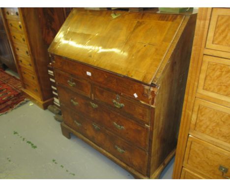 18th Century walnut bureau, the fall front enclosing a fitted interior with well above two short and two long graduated drawe