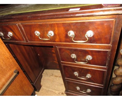 20th Century mahogany kneehole desk having green leather inset top above an arrangement of eight drawers with brass swan neck