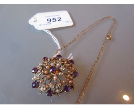 Circular yellow metal pendant brooch on chain set amethyst and seed pearls