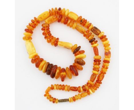 A string of graduated amber beads, comprising of button shaped beads and rectangular flattened beads, approx. 117 beads of di