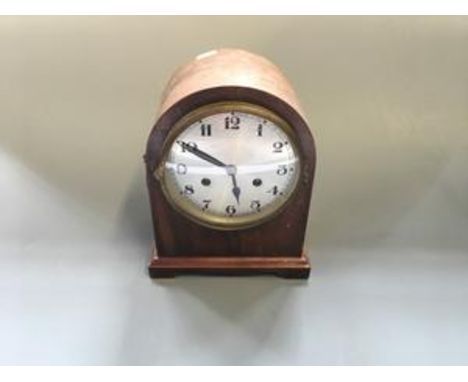 A mahogany mantle clock with lion handle decoration to sides.