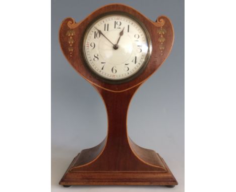 A mahogany SFRA balloon mantel clock with floral inlay design.