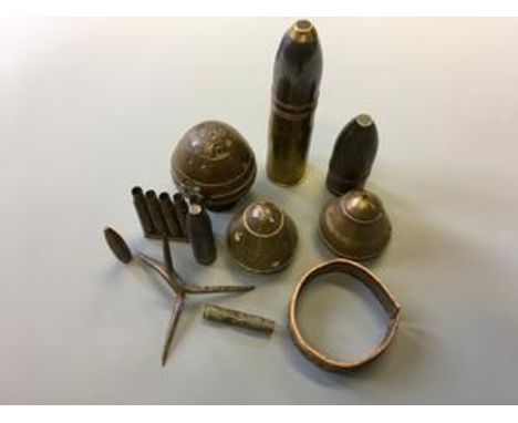 Three WWI brass shell nose cones, two small shells, bullet casings, bag of relics and spike.