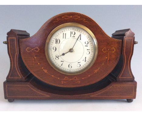 A mahogany swing mantel clock with inlay design.