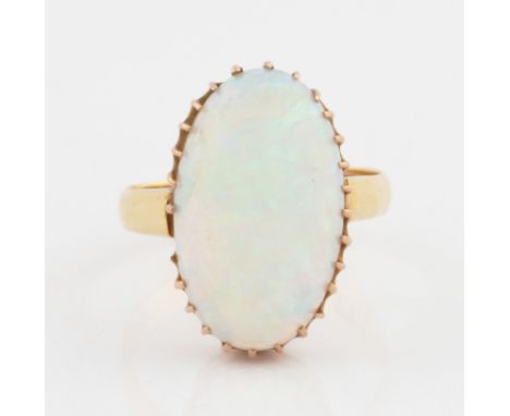 An opal dress ring, set with an oval opal cabochon, measuring approx. 19x11mm, set in yellow metal, markings rubbed indistinc