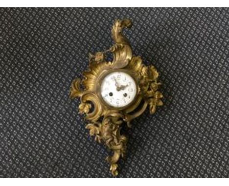A French style brass cased wall clock with cherub and roses