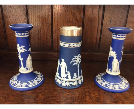 A pair of blue and white Wedgwood candlestick holders with similar silver rimmed vase.