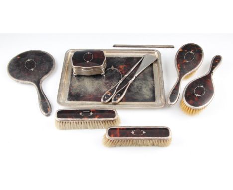 A matched Mappin & Webb tortoiseshell dressing table set, comprising of a tray, mirror, two hair brushes, two hand brushes, t