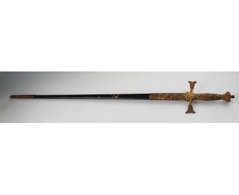 A dress sword with brass hilt with skull and cross bones, in triangle in scabbard.