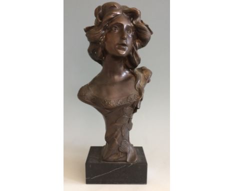 A bronze bust sculpture of female, mounted on marble.