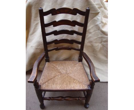 A 19th Century ash Lancashire ladderback armchair with rush seat. 