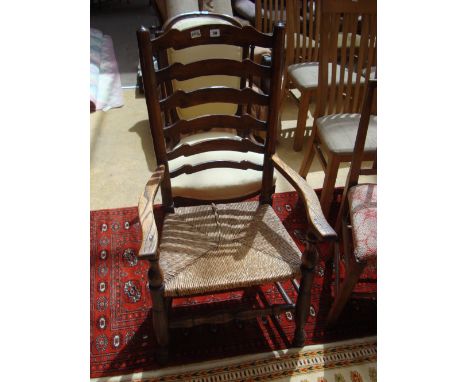 A 19th Century ash Lancashire ladderback low armchair. 