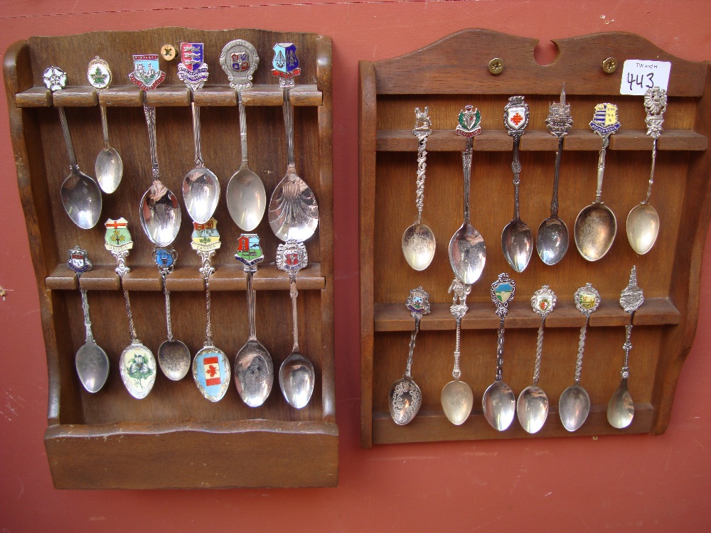 A collection of souvenir spoons in two display racks.