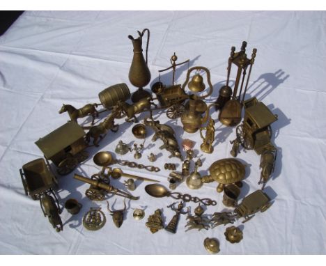 A mixed lot of brass including horses and carriages, fire tools, small figures, tankards, bell etc. 