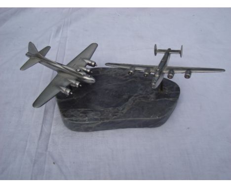 Two model aluminium wartime aeroplanes (Lancaster) by D.P Carter.  On marble base with rotation possible.  Wingspan of each a