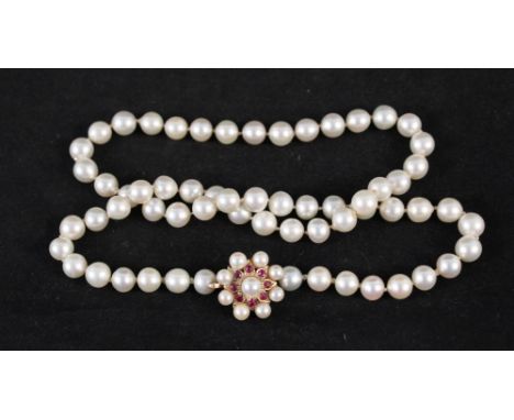 A pearl necklace with large 9ct gold clasp set with pearls and rubies in flower shape