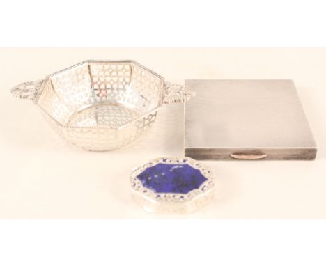 A silver engine turned Art Deco compact with gold highlights, a small silver pierced dish and a white metal pill box with blu