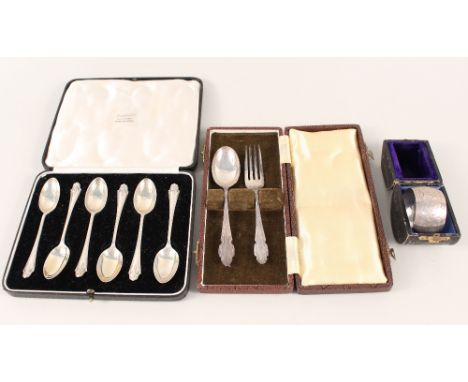 A set of six silver teaspoons in box, a boxed silver fork and spoon plus a silver napkin ring in box