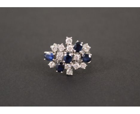 An 18ct white gold sapphire and diamond cluster ring, size L