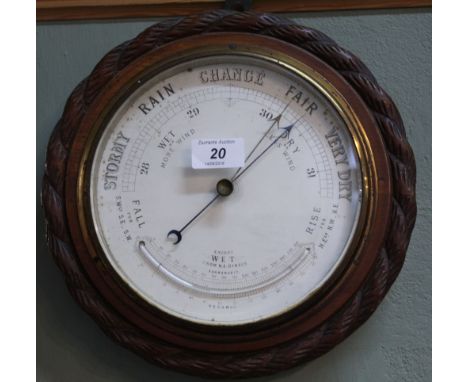 A circular carved mahogany barometer