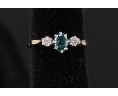 A three stone emerald and diamond ring, marks rubbed, size M