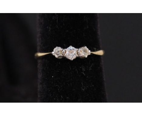 An 18ct gold three stone diamond ring, size N