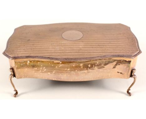 A large silver box of shaped legs with engine turned decoration to lid, maker Walker and Hall