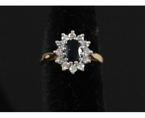 An 18ct gold sapphire and diamond cluster ring, size J