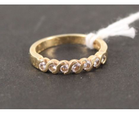 An 18ct gold ring set with seven diamonds, size M 1/2