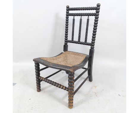 An antique Bowen &amp; Mallon ebonised bobbin turned chair with cane seat. Initialled F L on back of seat. 