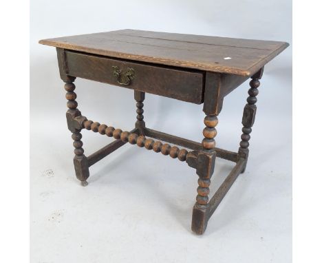 A 17th century oak side table, with single frieze drawer and bobbin turned supports. 85x68x58cm 