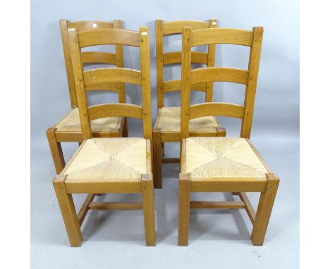 A set of four contemporary light oak rush seated ladder back dining chairs 