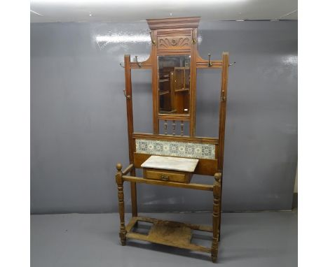 A Victorian Arts &amp; Crafts mirror back hallstand, tiled panel and marble shelf. 102x207x35cm 