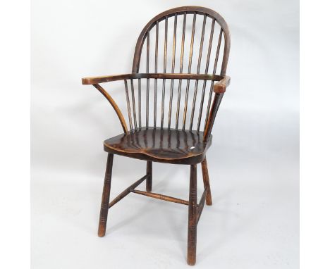 An Antique oak and elm-seated stick-back elbow chair. 