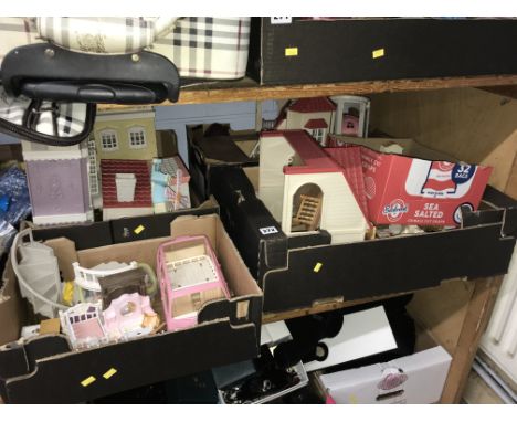 Shelf of Sylvanian Family figures, accessories and play sets