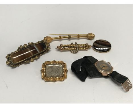 A Ladies 9ct gold watch, a Tigers Eye brooch, a Memorial brooch, agate brooch and a seed pearl brooch