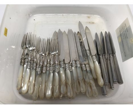 A set of mother of pearl handled fruit knives and forks and six silver handled knives