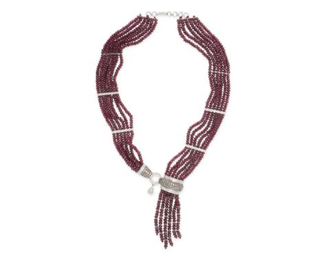 A RUBY AND DIAMOND TASSEL NECKLACE in 18ct white gold,&nbsp;comprising six rows of faceted ruby beads accented by spacers set